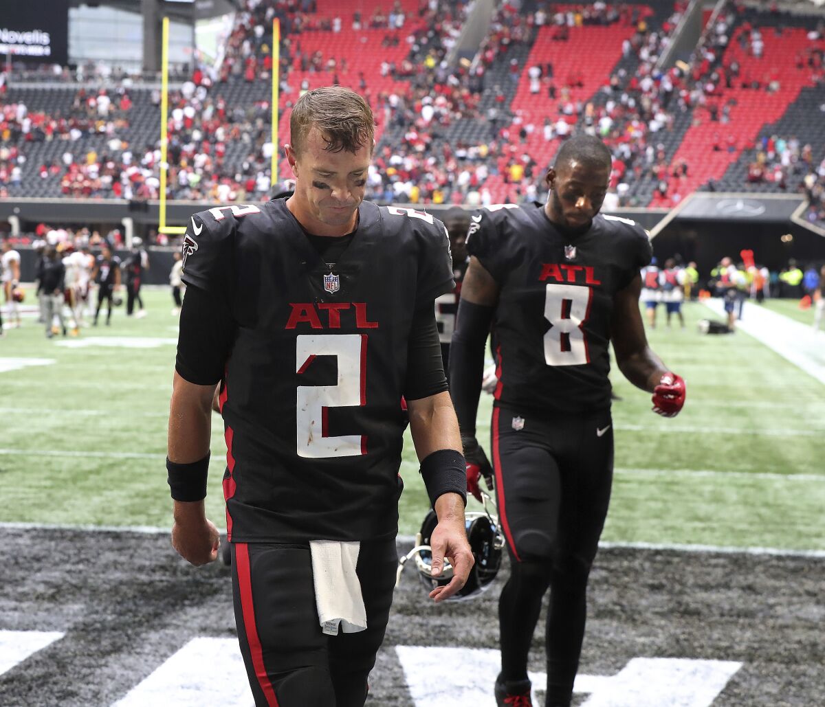 Atlanta Falcons quarterback Matt Ryan (2) and tight end Kyle Pitts (8) walk off the field after losing to the Washington Football Team in an NFL football game on Sunday, Oct. 3, 2021, in Atlanta. (Curtis Compton/Atlanta Journal-Constitution via AP)