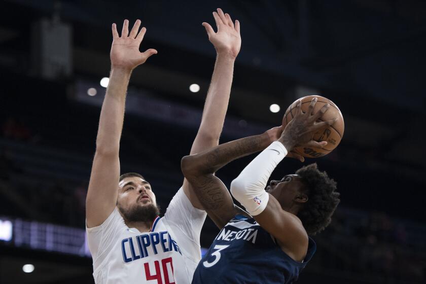 Minnesota Timberwolves forward Jaden McDaniels, right, shoots over Los Angeles Clippers center Ivica Zubac during the first half of an NBA preseason basketball game Monday, Oct. 11, 2021 in Ontario, Calif. (AP Photo/Kyusung Gong)