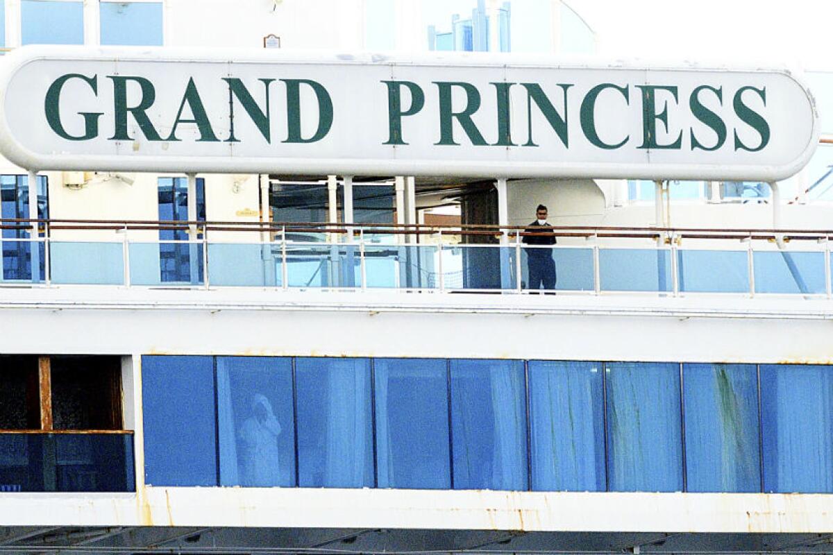 A man wearing a mask is pictured aboard the Grand Princess on Sunday.