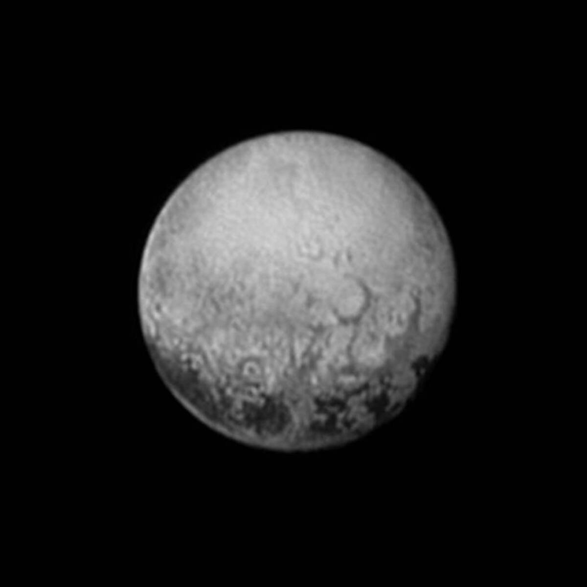 An image taken by the New Horizons spacecraft and released by NASA on Saturday shows Pluto's mysterious dark spots, which are evenly spaced apart and about 300 miles across each.