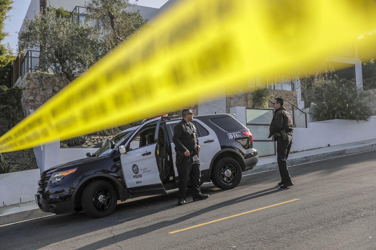 LAPD officers closed the road leading to a homicide scene in the Hollywood Hills, where rapper Pop Smoke was fatally shot