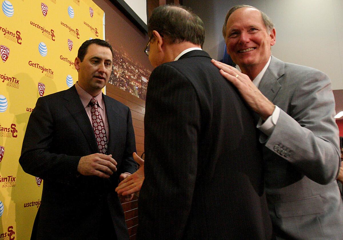 USC Athletic Director Pat Haden talks with university President C.L. Max Nikias and, at the time, new football coach Steve Sarkisian, left, during his introductory news conference.