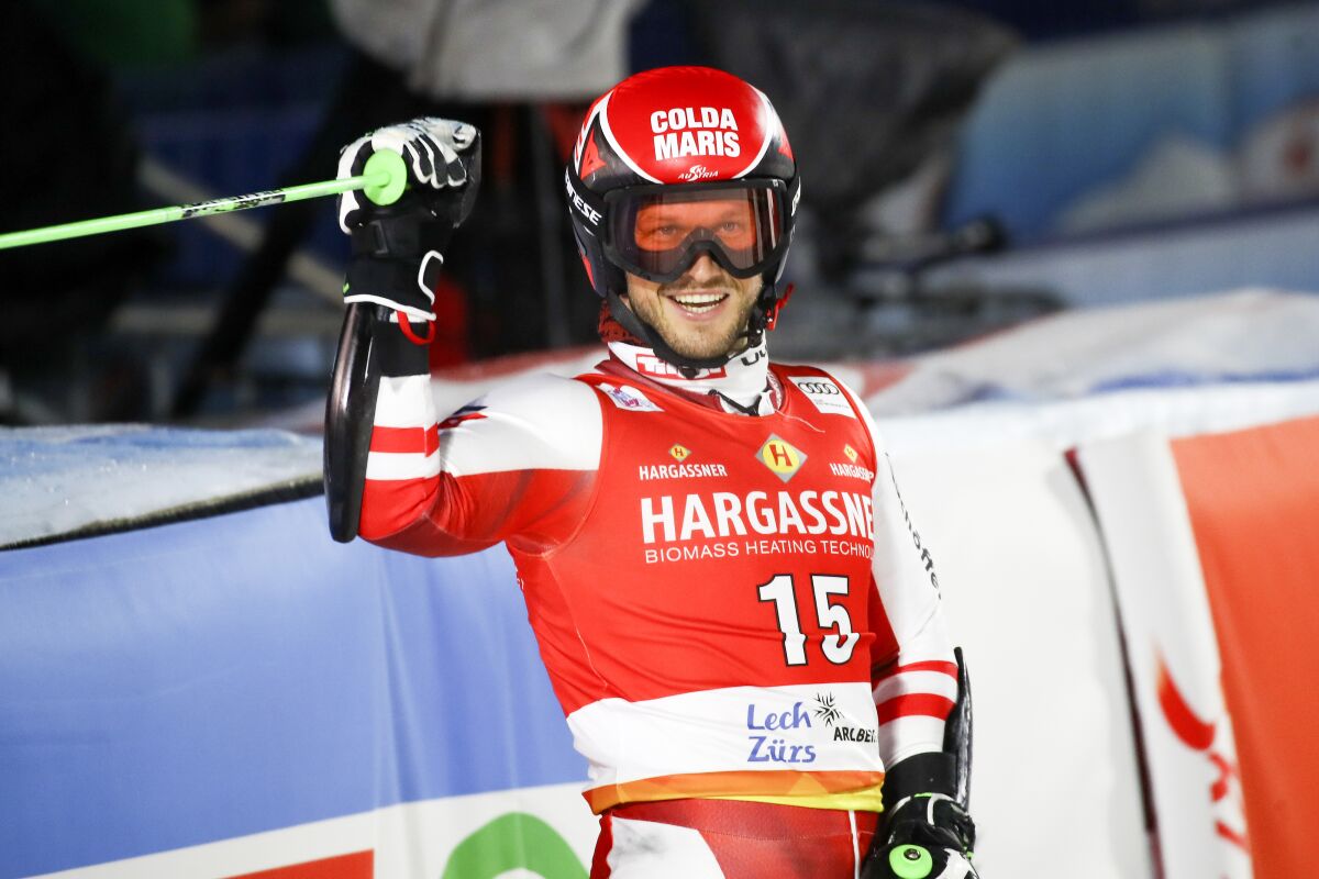 Austria's Christian Hirschbuehl celebrates winning an alpine ski, men's World Cup parallel event, in Lech/Zuers, Austria, Sunday, Nov. 14, 2021. (AP Photo/Marco Trovati)