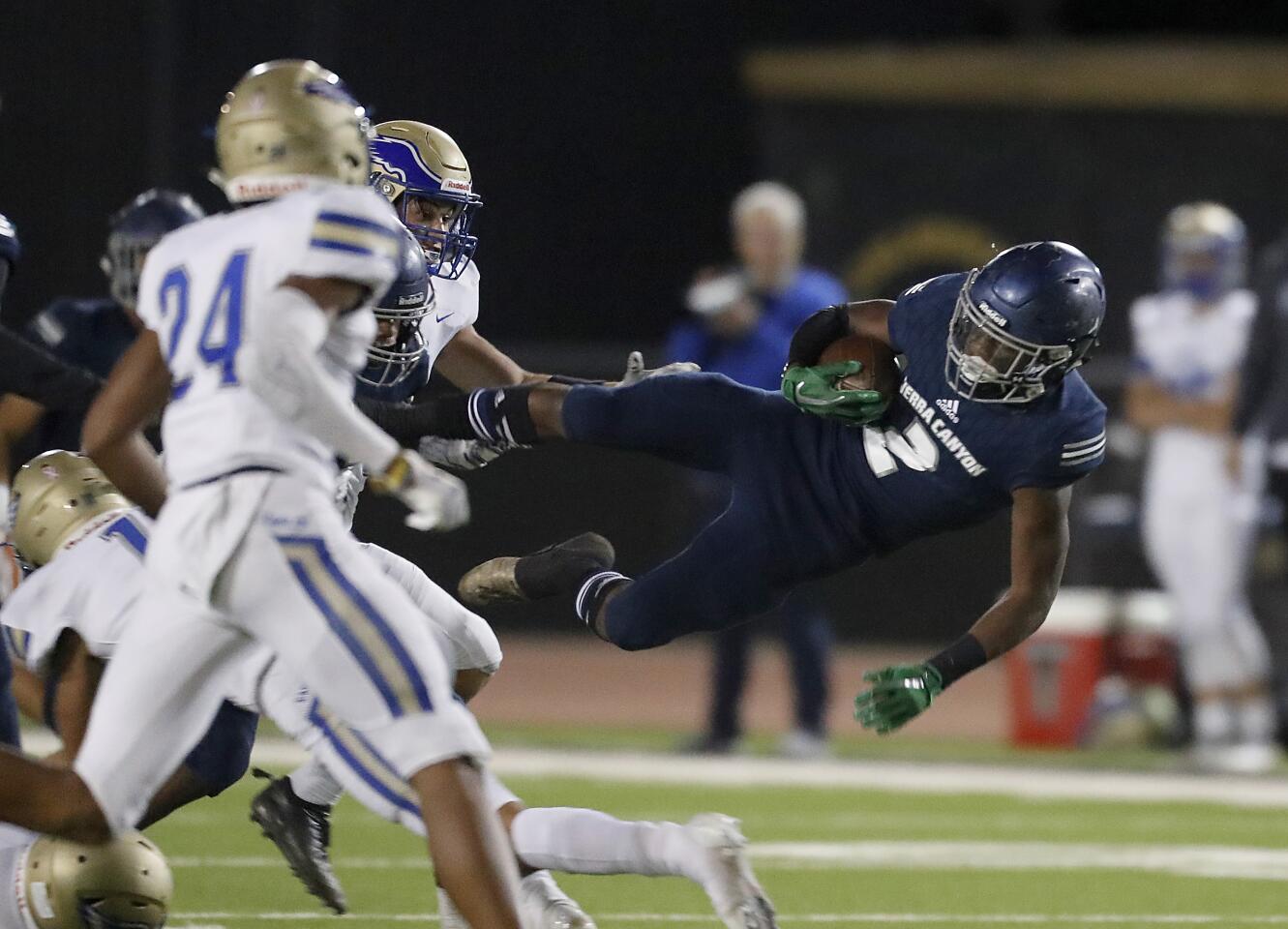 Sierra Canyon's DJ Harvey gets airborne after a catch-and-run play against Santa Margarita.
