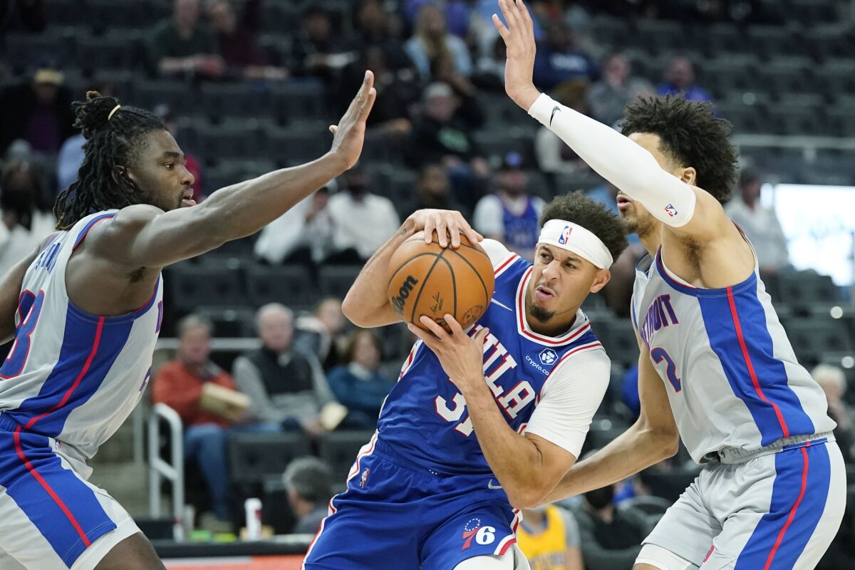 Philadelphia 76ers guard Seth Curry (31) is defended by Detroit Pistons center Isaiah Stewart, left, and guard Cade Cunningham (2) during the second half of an NBA basketball game, Thursday, Nov. 4, 2021, in Detroit. (AP Photo/Carlos Osorio)