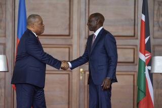 Haiti Prime Minister Garry Conille, left, and Kenya's President William Ruto, right, shake hands after a joint at State House in Nairobi, Kenya, Friday, Oct. 11, 2024. (AP Photo/Brian Inganga)