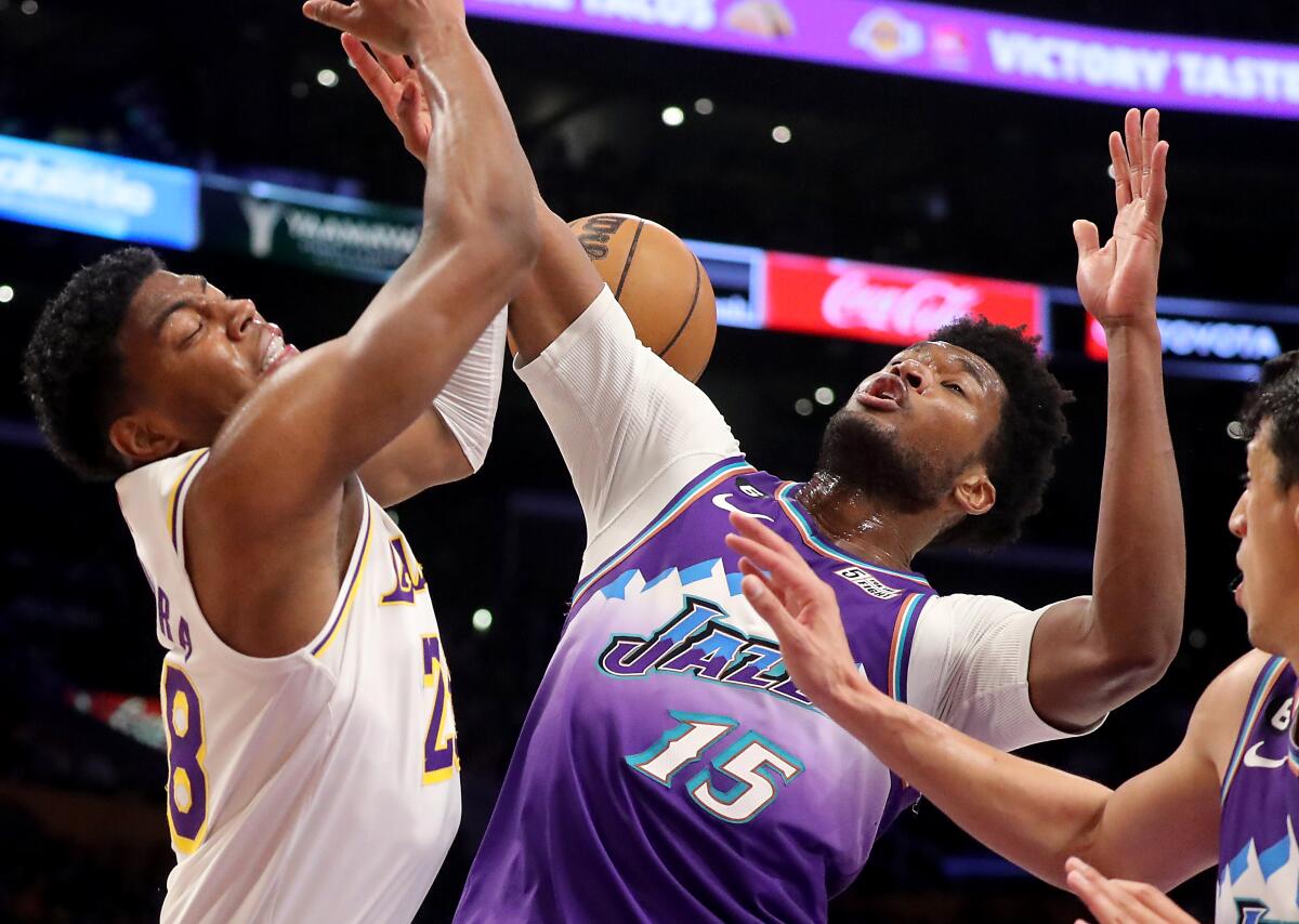 Lakers forward Rui Hachimura, left, battles for a rebound against Utah Jazz center Damian Jones.