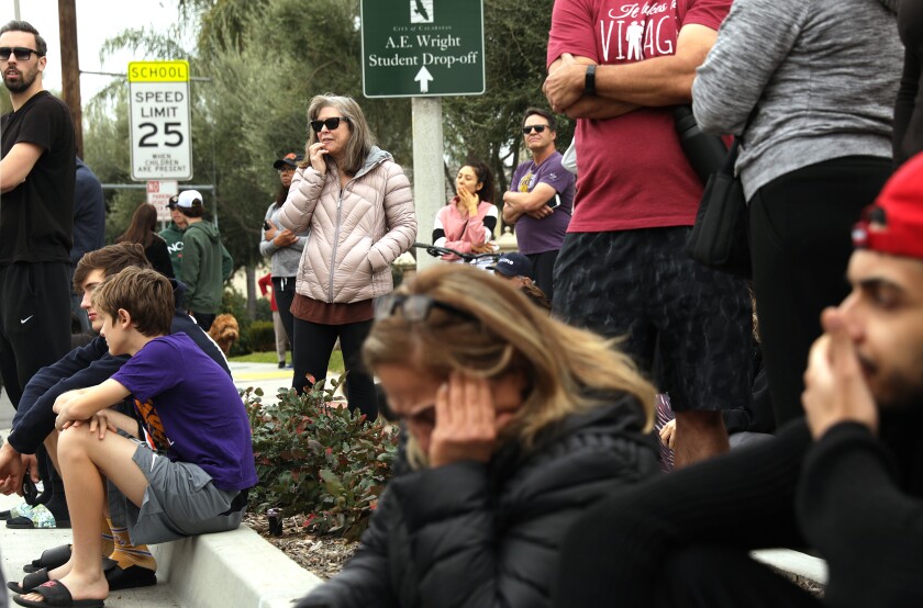 Fans gather at Las Virgenes Road and Willow Glen Street in Calabasas, near the site of the helicopter crash that killed Kobe Bryant, daughter Gianna and seven others.