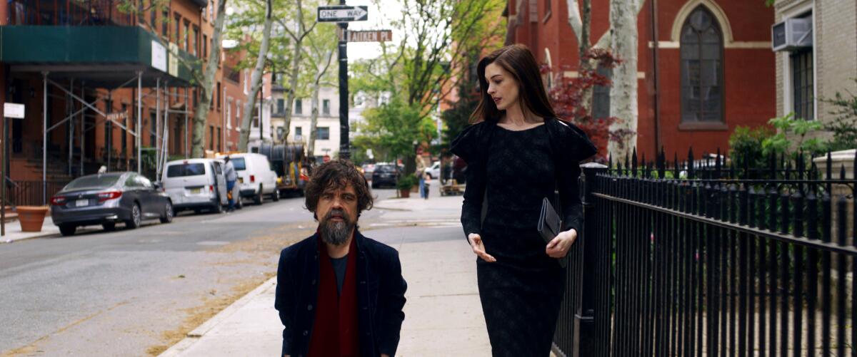 A man and a woman walk down Joralemon Street in Brooklyn Heights.