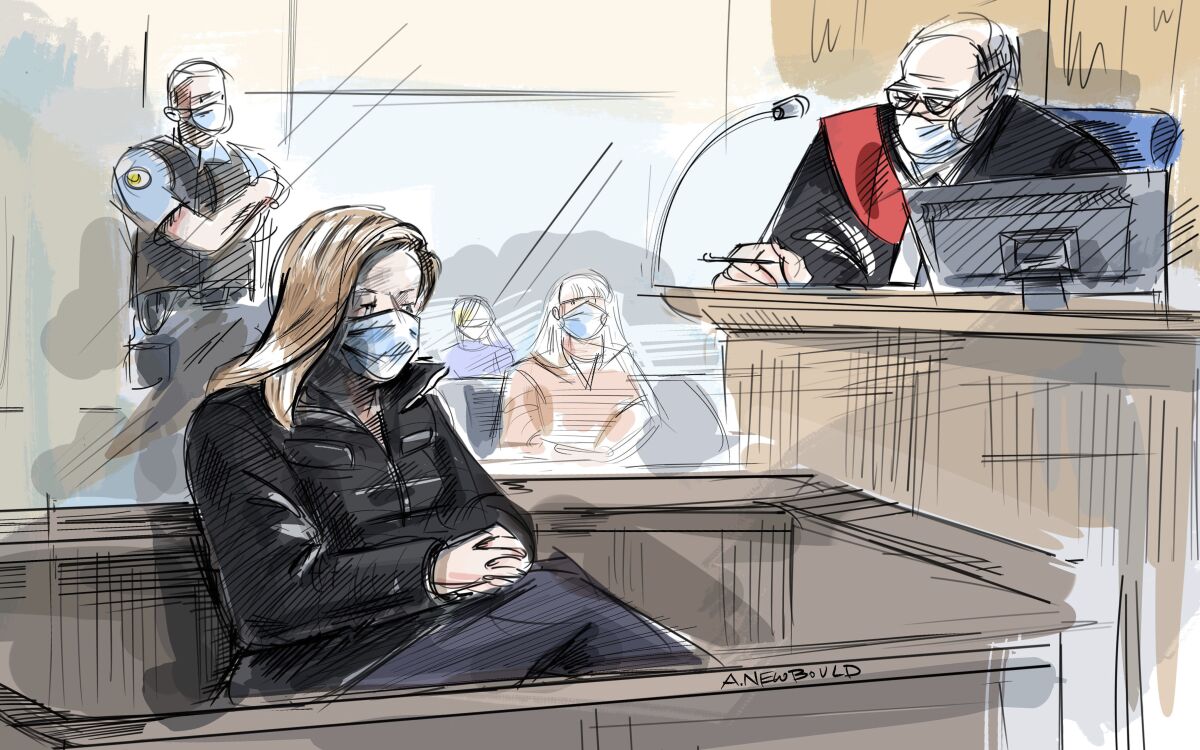 In this courtroom sketch, Tamara Lich appears at her bail hearing in Ottawa, Monday, March 7, 2022 as Justice John M. Johnston looks on. Lich, one of the principal organizers of the so-called ''Freedom Convoy'' protest that gridlocked downtown Ottawa for three weeks, has been granted bail on a $25,000 bond. (Alexandra Newbould/The Canadian Press via AP)