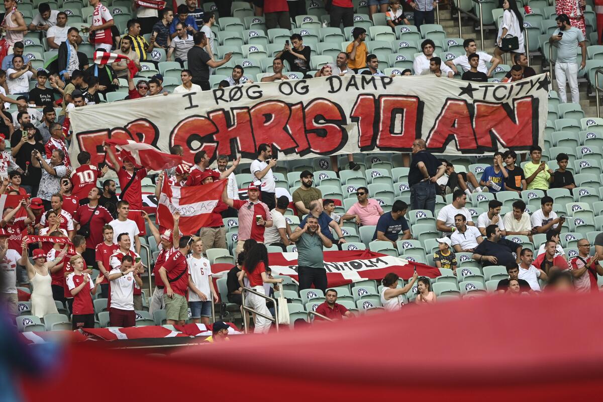 Danish supporters hold a banner for Christian Eriksen, during the Euro 2020 soccer championship quarterfinal match between Czech Republic and Denmark, at the Olympic stadium in Baku, Saturday, July 3, 2021. (Ozan Kose, Pool via AP)