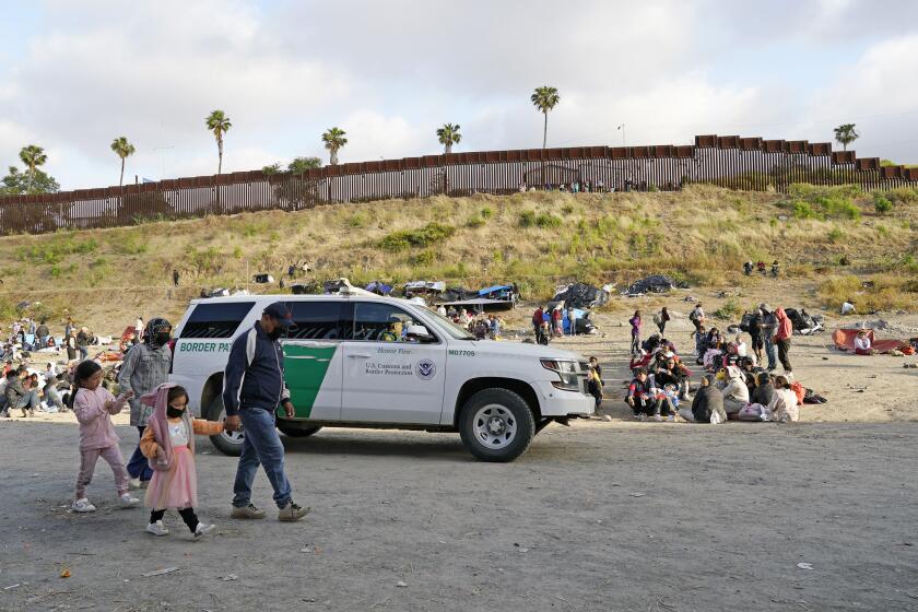 San Diego, May 11 - A CBP truck make its way between the fences at Dairy Mart Rd. as migrants wait for the end of Title 42 in San Diego, CA on Thursday, May 11, 2023. (Nelvin C. Cepeda / The San Diego Union-Tribune)
