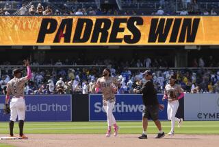 San Diego Padres right fielder Fernando Tatis Jr., center, celebrates with teammates second baseman Xander Bogaerts, left, and outfielder Jose Azocar after the Padres defeated the Los Angeles Dodgers 4-0 in a baseball game, Sunday, May 12, 2024, in San Diego. (AP Photo/Gregory Bull)