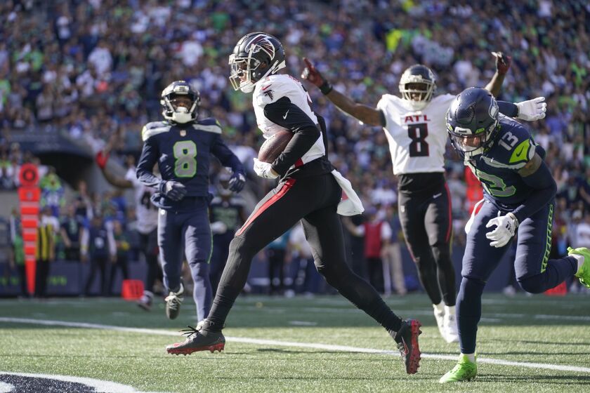 Atlanta Falcons wide receiver Drake London, center, scores a touchdown during the second half of an NFL football game against the Atlanta Falcons, Sunday, Sept. 25, 2022, in Seattle. (AP Photo/Ashley Landis)
