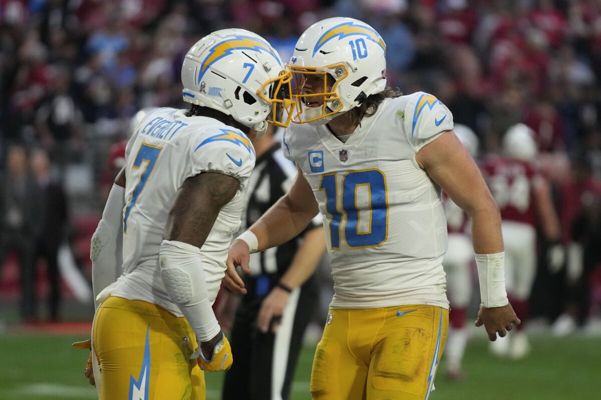 Chargers Justin Herbert (10) and Gerald Everett (7) celebrate their winning two-point conversion pass against Arizona.