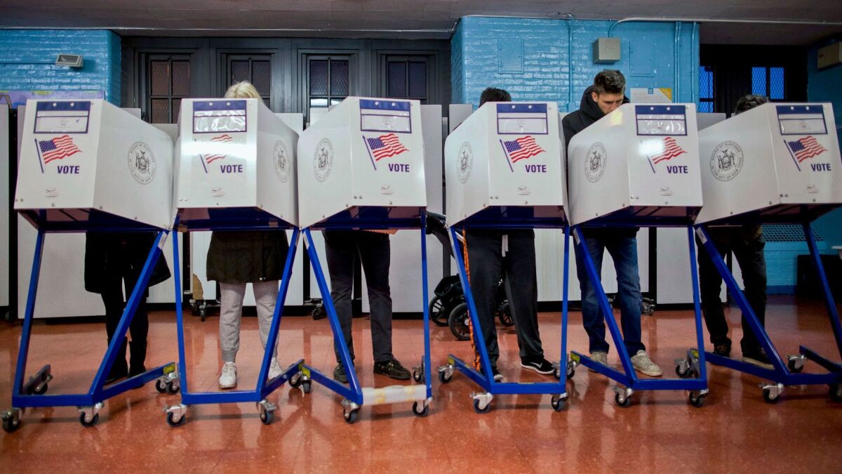 Voters mark their ballots in Brooklyn, N.Y., on Nov. 8, 2016. The Trump administration's intelligence chief has warned that the 2018 midterm elections may be a target for Russian hackers.