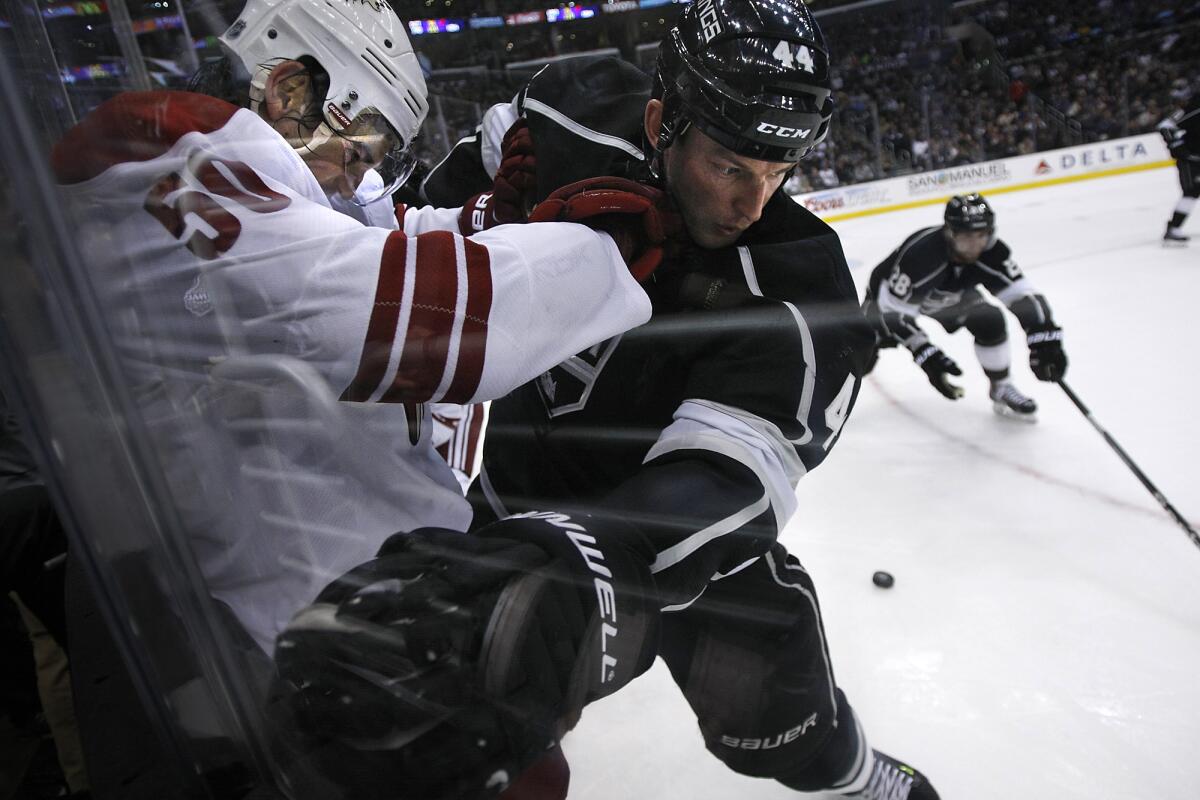 Robyn Regehr battles Phoenix's Antoine Vermette, left, on the boards back in April.