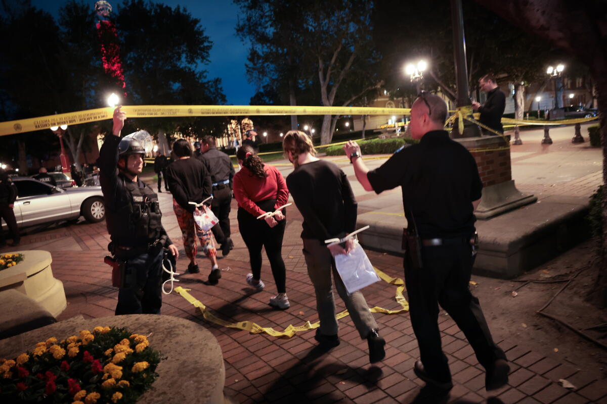 Students are apprehended by Los Angeles police officers