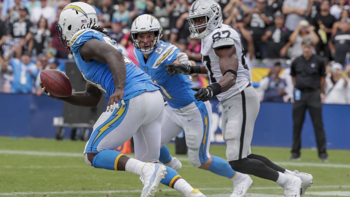 Chargers linebacker Melvin Ingram III intercepts a pass from Oakland Raiders quarterback Derek Carr, stopping a third-quarter drive in the end zone at StubHub Center on Sunday.