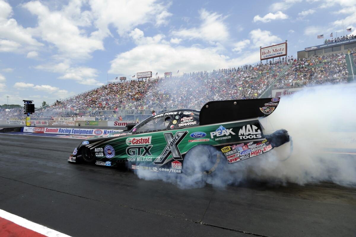John Force does a burnout in his Castrol GTX High Mileage Ford Mustang on July 6 after his 140th career victory.