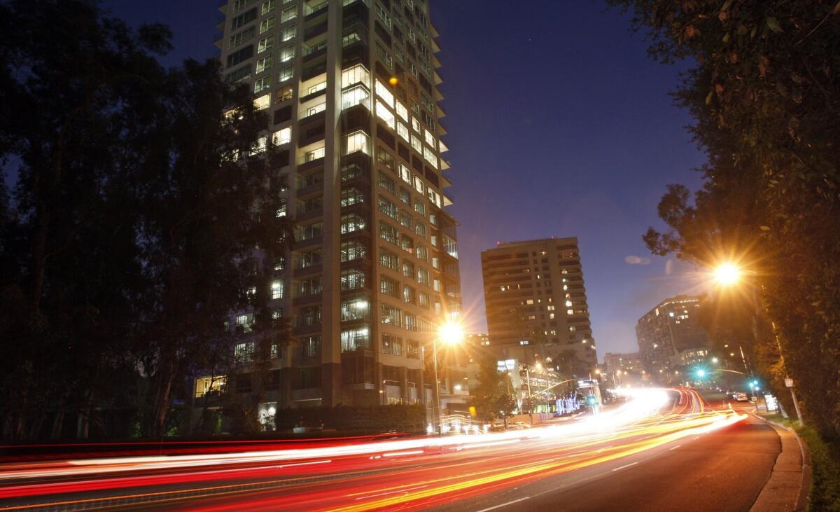 Traffic streams along Wilshire Boulevard as the verdant expanse of the Los Angeles Country Club gives way to the high-rise residential buildings of Westwood.