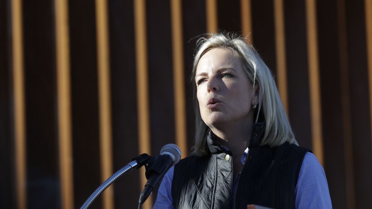 Homeland Security Secretary Kirstjen Nielsen speaks in front of a newly fortified border barrier on Oct. 26 in Calexico, Calif.