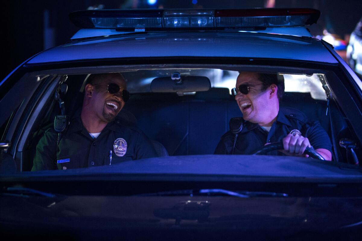 This image released by 20th Century Fox shows Damon Wayans Jr., left, and Jake Johnson in a scene from "Let's Be Cops."