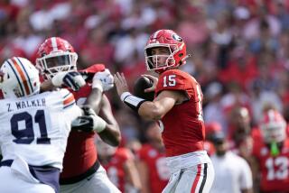 Georgia quarterback Carson Beck (15) throws from the pocket in the first half.