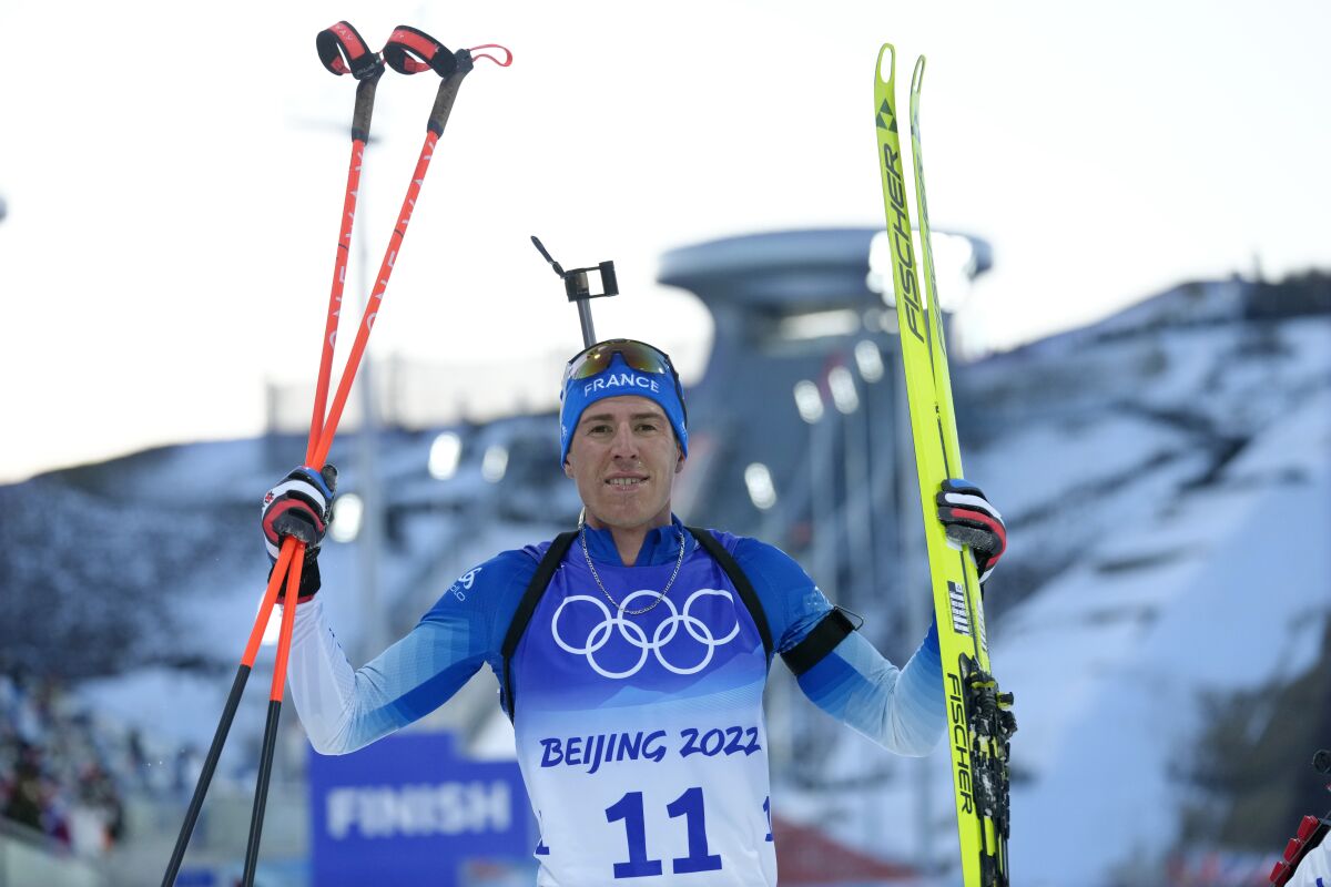 Quentin Fillon Maillet of France stands at the finish line during the men's 20-kilometer individual race at the 2022 Winter Olympics, Tuesday, Feb. 8, 2022, in Zhangjiakou, China. (AP Photo/Kirsty Wigglesworth)