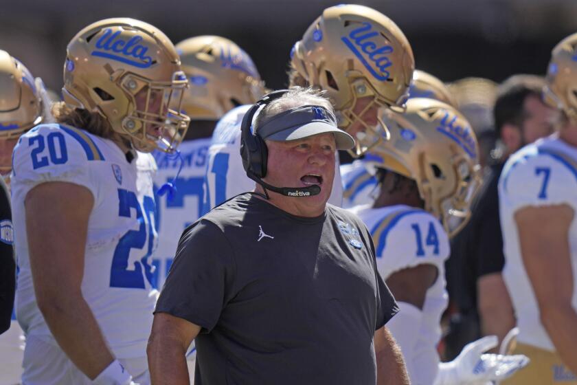 UCLA head coach Chip Kelly looks on from the sidelines during the first half of an NCAA.