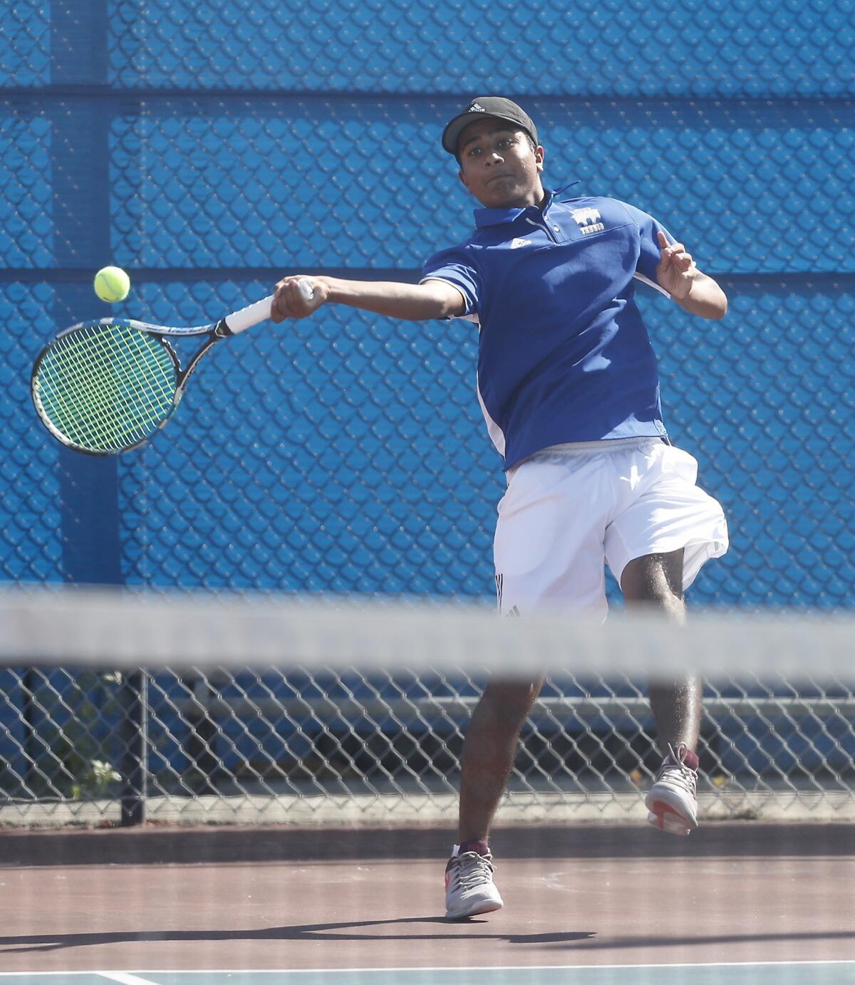 Fountain Valley High No. 1 doubles player Vivek Savsani hits against Corona del Mar in a Surf League match at Fountain Valley on Tuesday.