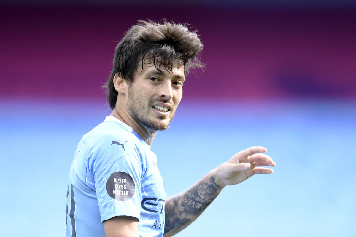 Manchester City's David Silva walks on the pitch during the English Premier League soccer match between Manchester City and Norwich City at the Etihad Stadium in Manchester, England, Sunday, July 26, 2020. (Peter Powelll/Pool via AP)