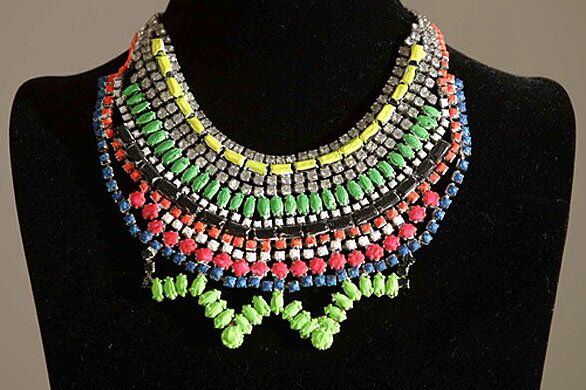 A crystal and neon necklace, made of hand painted rhodium and crystal created by Tom Binns.
