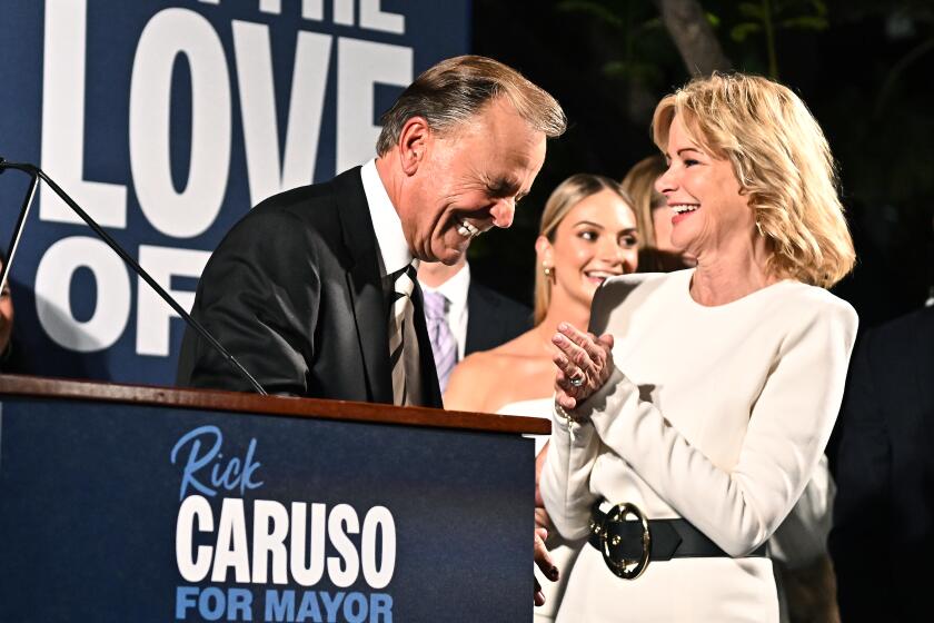 Los Angeles, California June 7, 2022-L.A. Mayoral candidate Rick Caruso and wife Tina share a laugh on election night at the Grove Tuesday night. (Wally Skalij/Los Angeles Times)