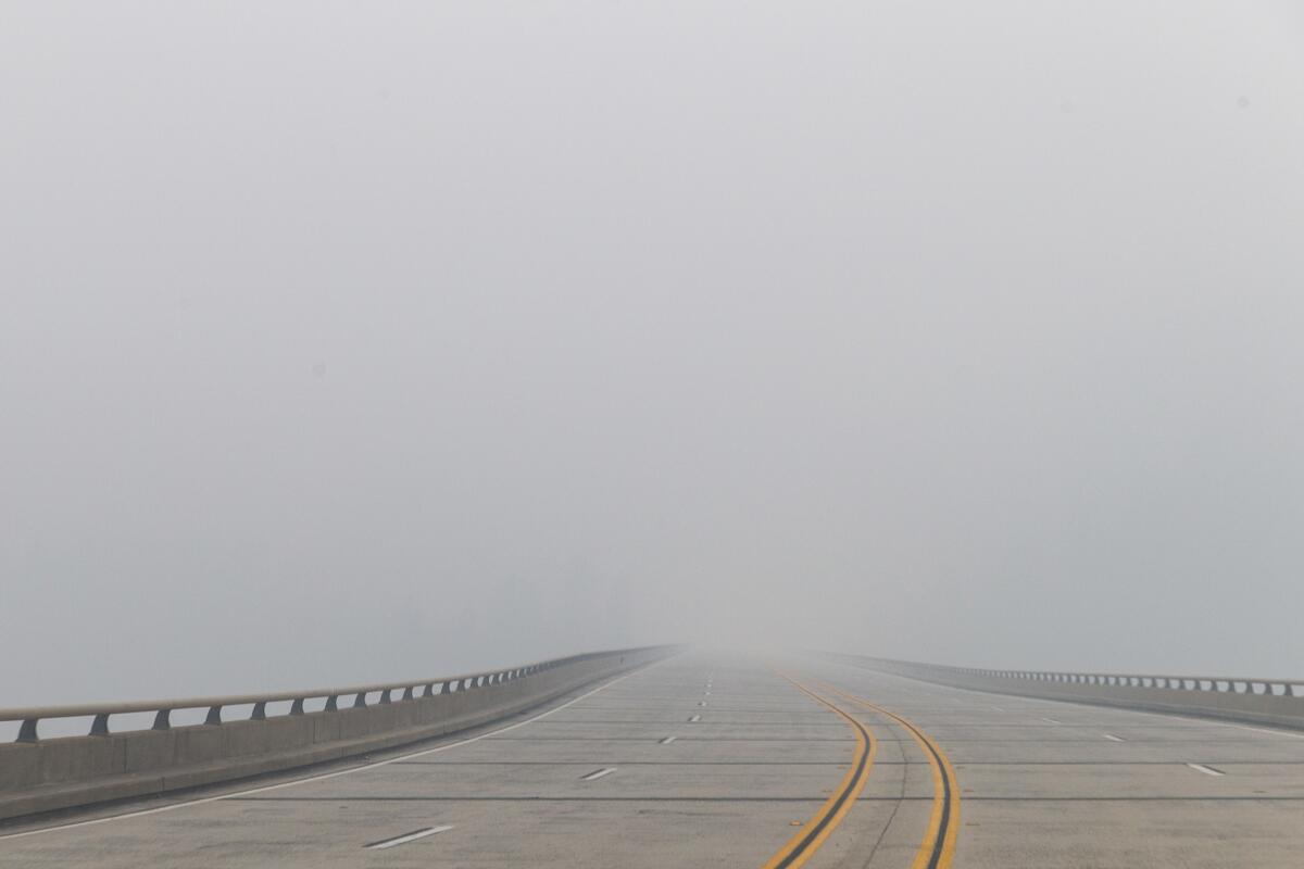 Smoke from the Camp fire obscures the view of Highway 70 near the Concow Reservoir.