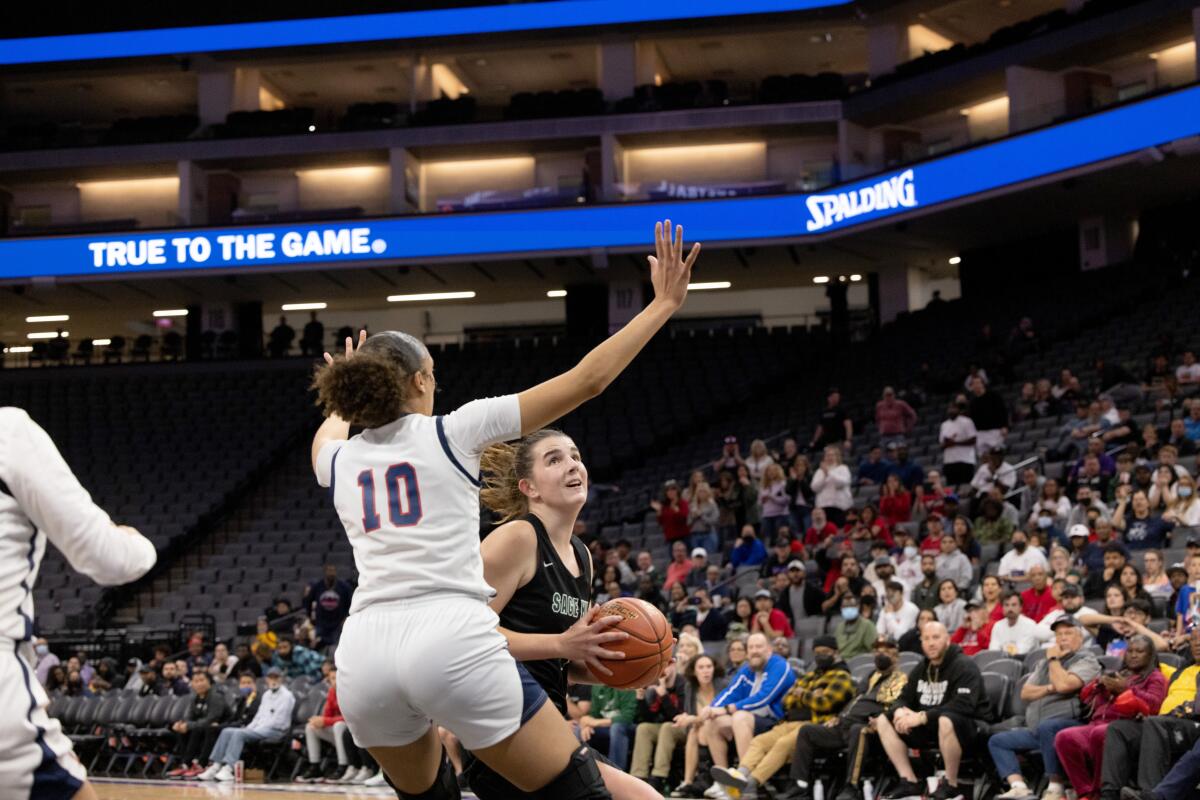 Sage Hill's Emily Eadie attacks the basket against San Joaquin Memorial's Alexis Swillis in the CIF State Division II final.