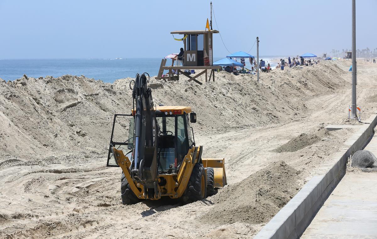 A sand berm was rebuilt to hold off big waves and high tides at Balboa Pier in Newport Beach. 