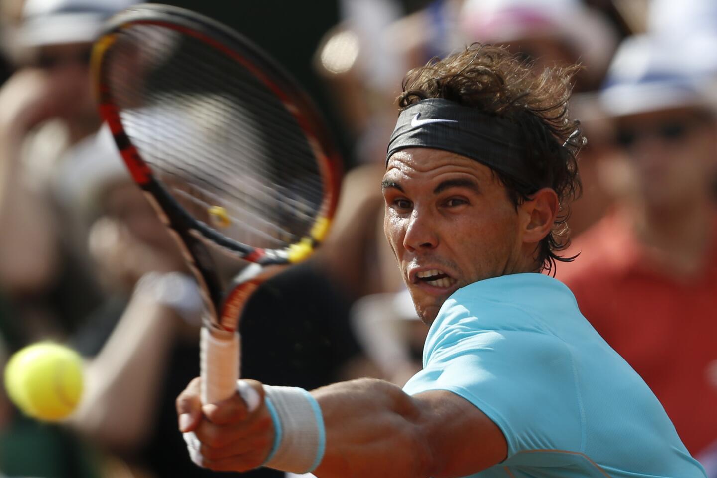 Rafael Nadal, the top-ranked player in the world, hits a patented top-spin forehard return against Novak Djokovic in the championship match of the French Open on Sunday.