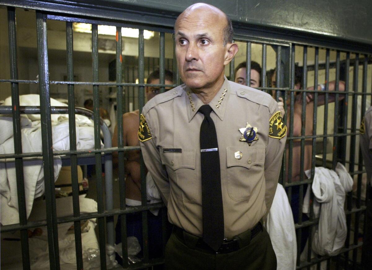 Former Los Angeles County Sheriff Lee Baca talks with members of the media as he leads a tour inside the Men's Central Jail at the Twin Towers Correctional Facility in Los Angeles in 2004.