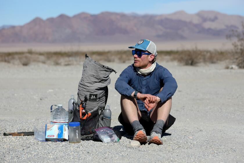 DEATH VALLEY, CA - FEBRUARY 18: Cameron Hummels, 43, of Pasadena, an astrophysicist, rest at the Harry Wade Exit Route located at Saratoga Springs Rd. and Death Valley Rd. on Friday, Feb. 18, 2022 in Death Valley, CA. Hummels beat a record time for traversing Death Valley National Park from north to south on foot. Cameron traversed Death Valley in just under four days, trekking over 50 miles on the final 24-hours. (Gary Coronado / Los Angeles Times)