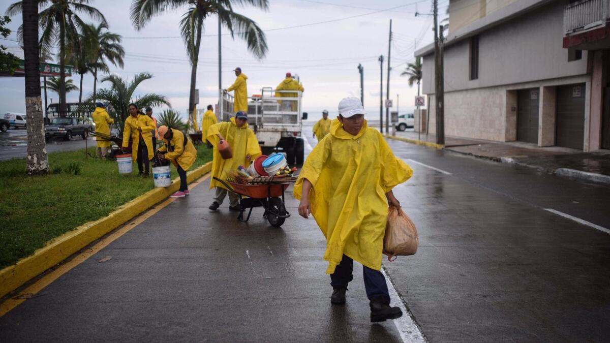 City workers clean the waterfront area of Veracruz, Mexico, after Hurricane Franklin came ashore on Aug. 10, 2017.