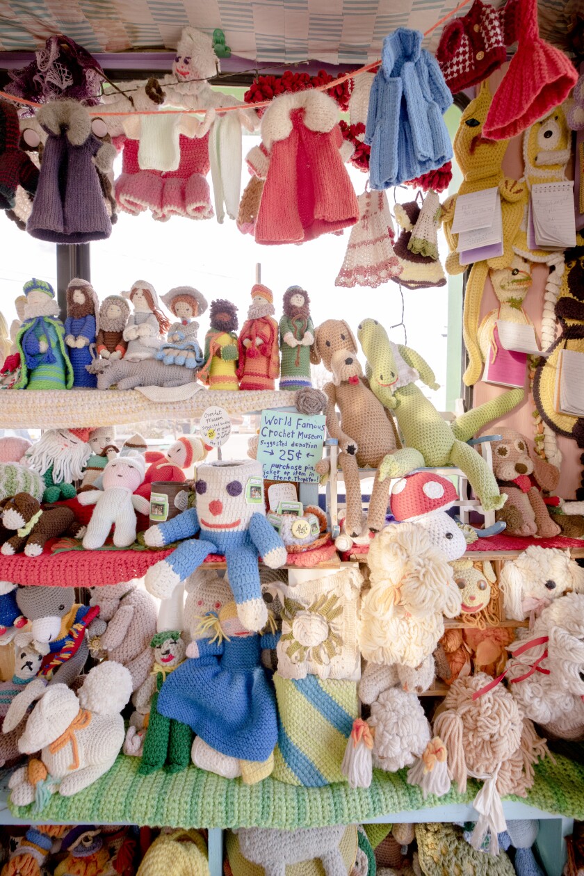 Several shelves full of crocheted animals.