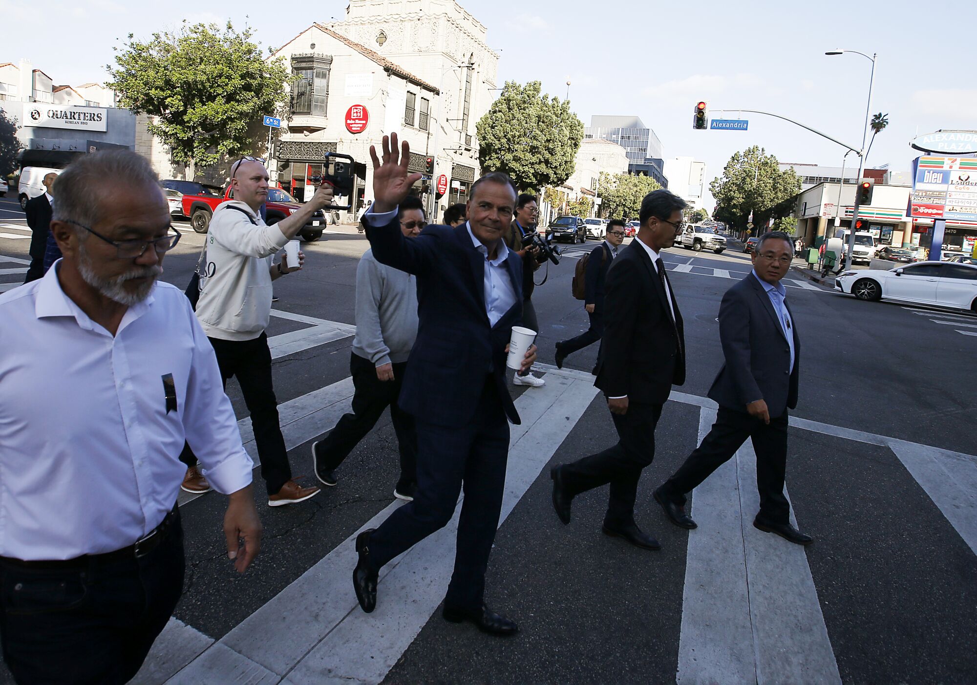 Los Angeles mayoral candidate Rick Caruso waves to motorists.