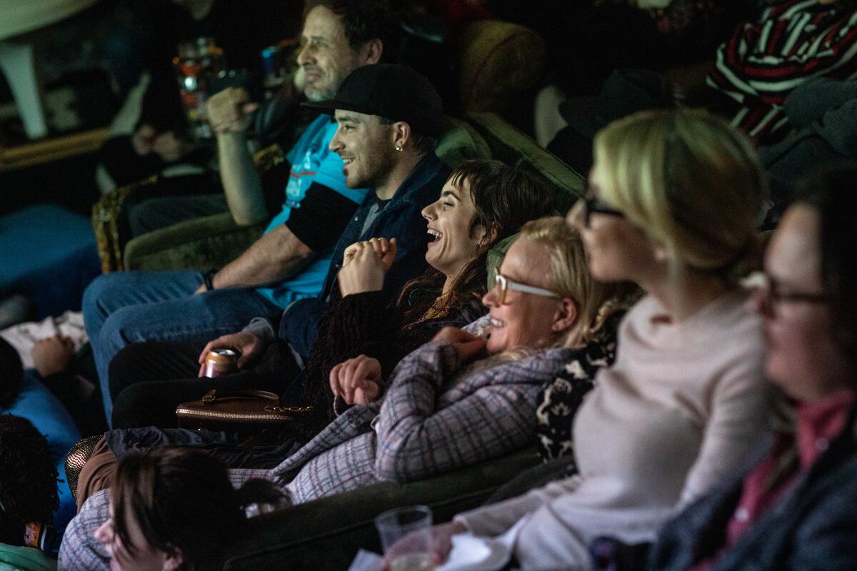 Zoe Bleu Sidel, center, Patricia Arquette and others watching a screening.