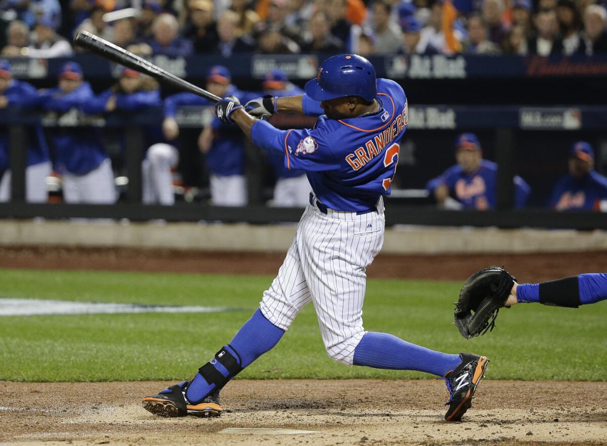 New York Mets outfielder Curtis Granderson (3) follows through on a double to centerfield, scoring three runs against the Dodgers during the second inning.