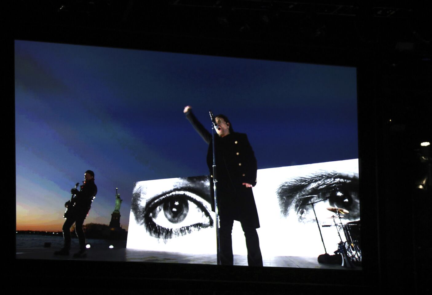 U2 appears via satellite as they perform "Get Out of Your Own Way" on the Hudson River.