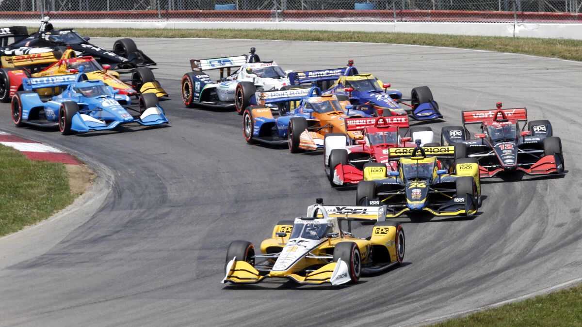 Josef Newgarden leads the field after taking the green flag at the start of an IndyCar race at Mid-Ohio Sports Car Course in Lexington, Ohio, Sunday, July 4, 2021. Newgarden snapped his streak of late race misfortunes Sunday to win for the first time this season, earning the first IndyCar victory of the year for Team Penske on the same weekend the storied organization celebrated the 50th anniversary of its first win. (AP Photo/Tom E. Puskar)