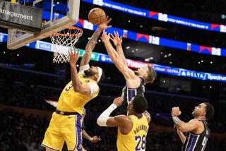 LOS ANGELES, CA - MARCH 6, 2024: Los Angeles Lakers forward Anthony Davis (3) battles Sacramento Kings forward Domantas Sabonis (10) for a rebound in the fourth quarter on March 6, 2024 at Crypto.com Arena in Los Angeles, California.(Gina Ferazzi / Los Angeles Times)