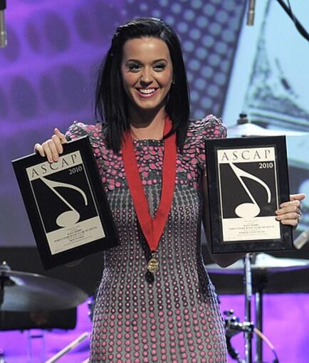 Katy Perry poses with her songwriter awards for "Hot N Cold" and "Waking Up In Vegas."