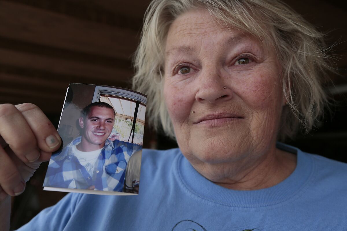 Anne Clemenson holds a photo of her son, Francis Pusok, who was beaten by San Bernardino County sheriff's deputies following a pursuit.